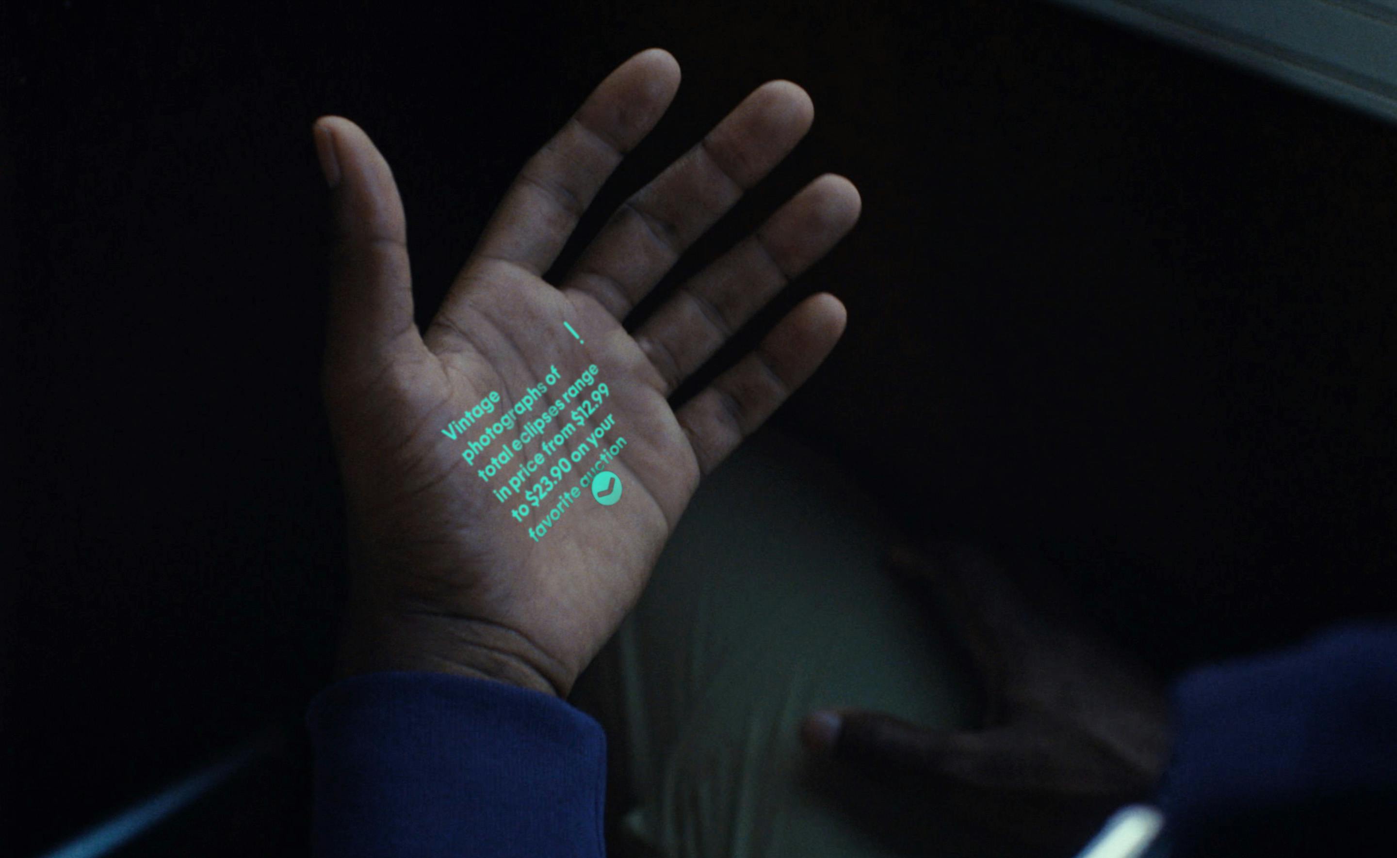 A hand displaying a projected laser